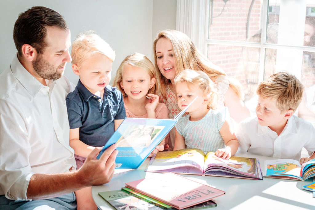 Reading books together during in-home lifestyle family photos in Dallas, Texas