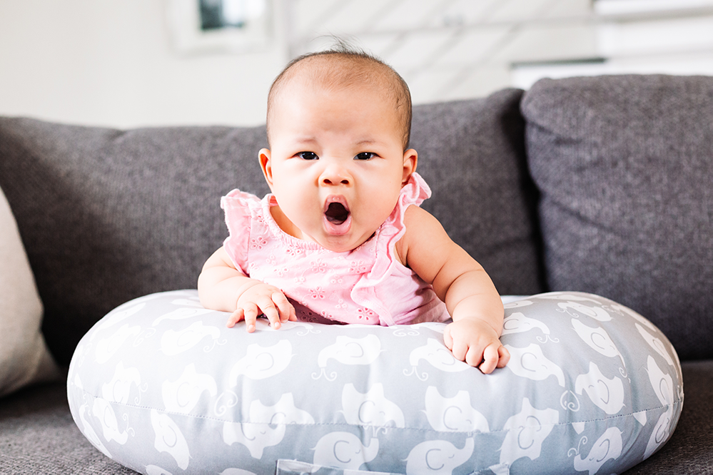 Baby girl yawning during newborn photos in Dallas, Texas